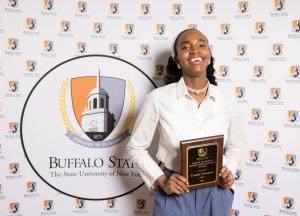 Student holding an award